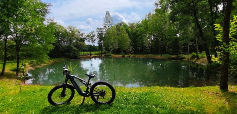 The Shengmilo MX05 electric bike riding through scenic landscapes, offering comfort, power, and stability across all types of terrain.