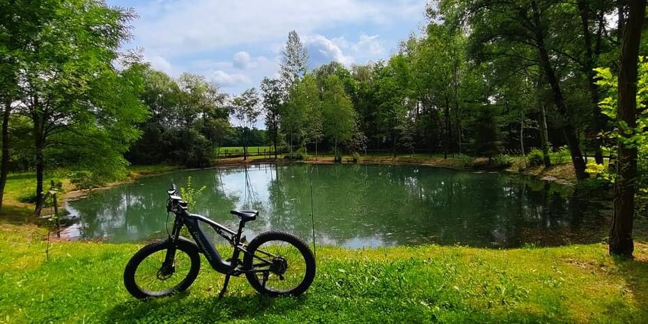 The Shengmilo MX05 electric bike riding through scenic landscapes, offering comfort, power, and stability across all types of terrain.